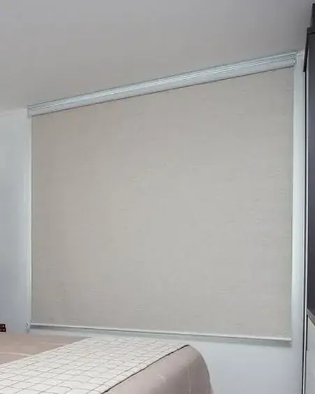 Sun-blocking roller blind in a bedroom, Mahboula